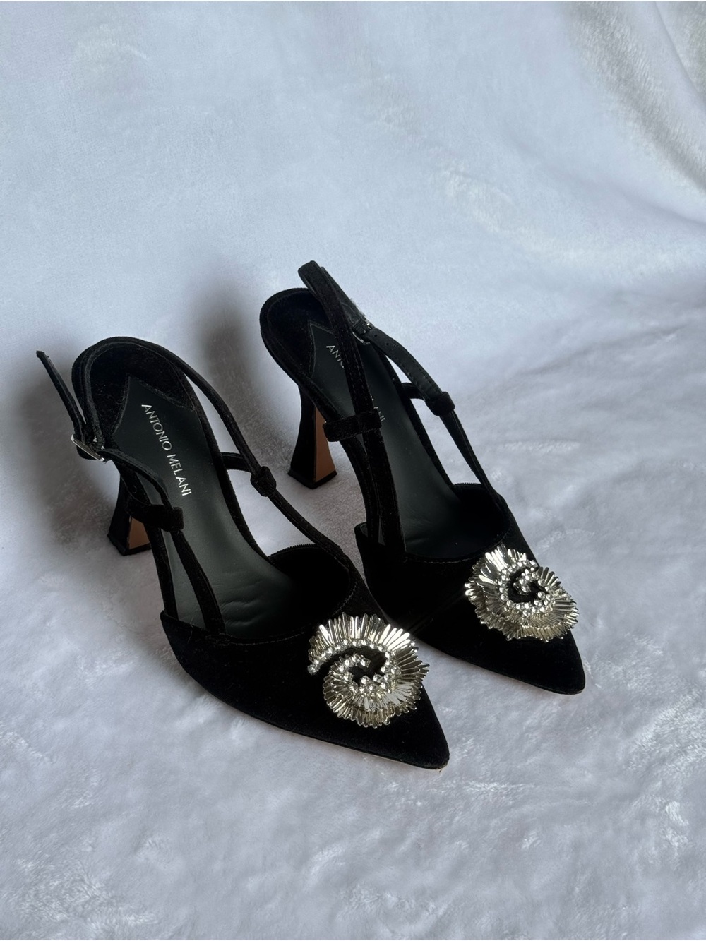 ANTONIO MELANI Black Pointed T-Strap Heels with Silver Floral Embellishment